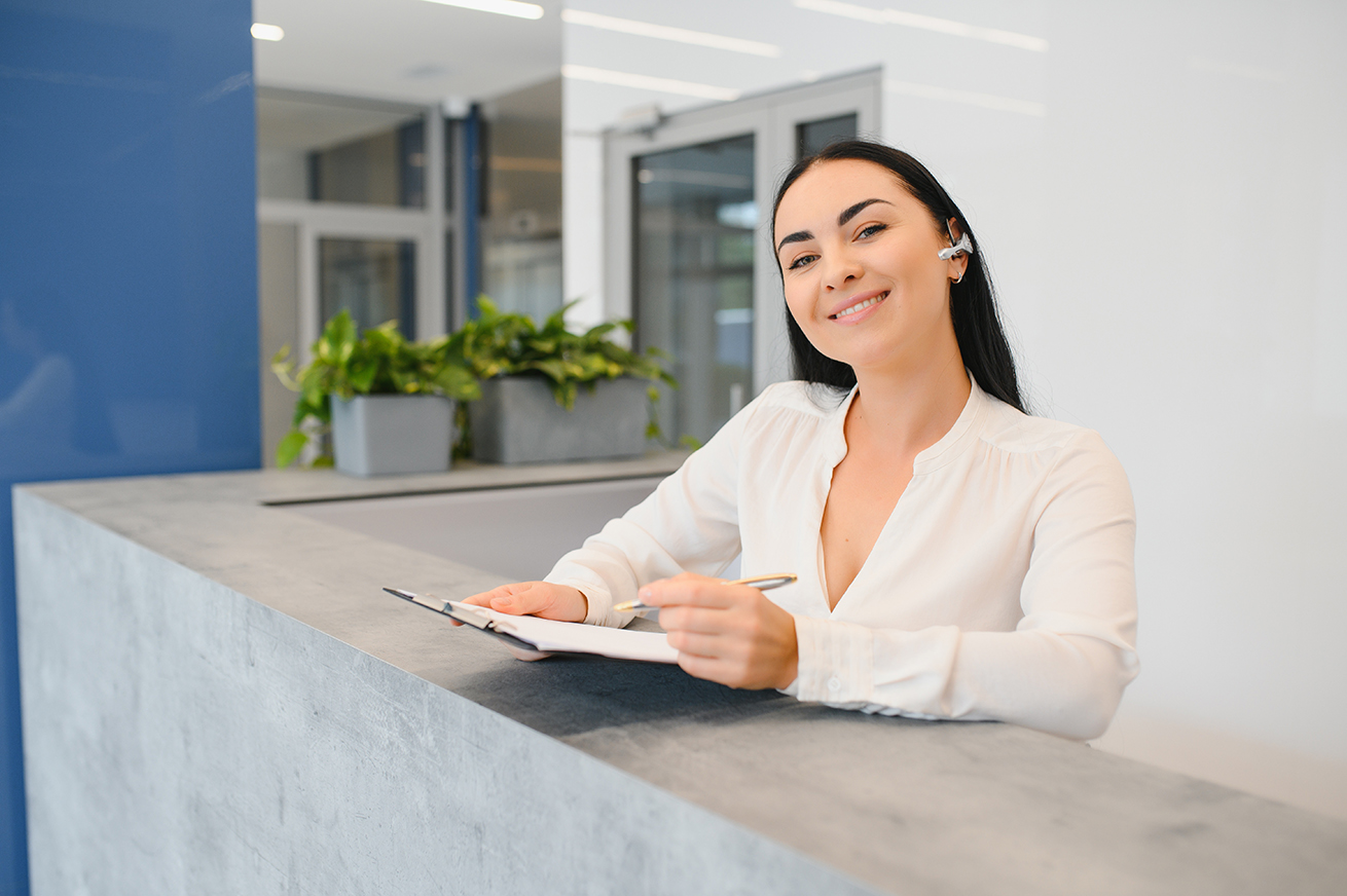 brunette woman receptionist working in reception of the beauty salon.