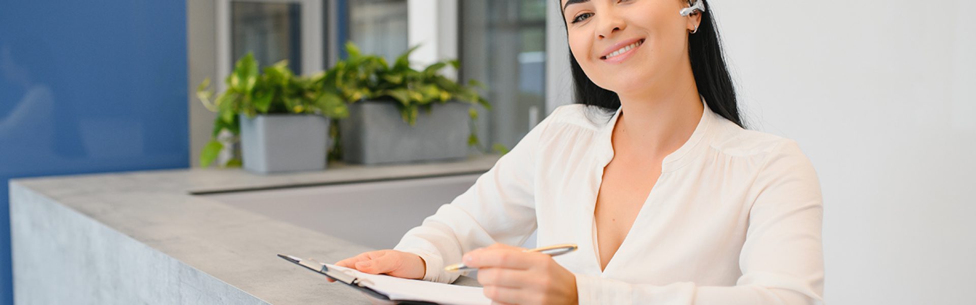 brunette woman receptionist working in reception of the beauty salon.